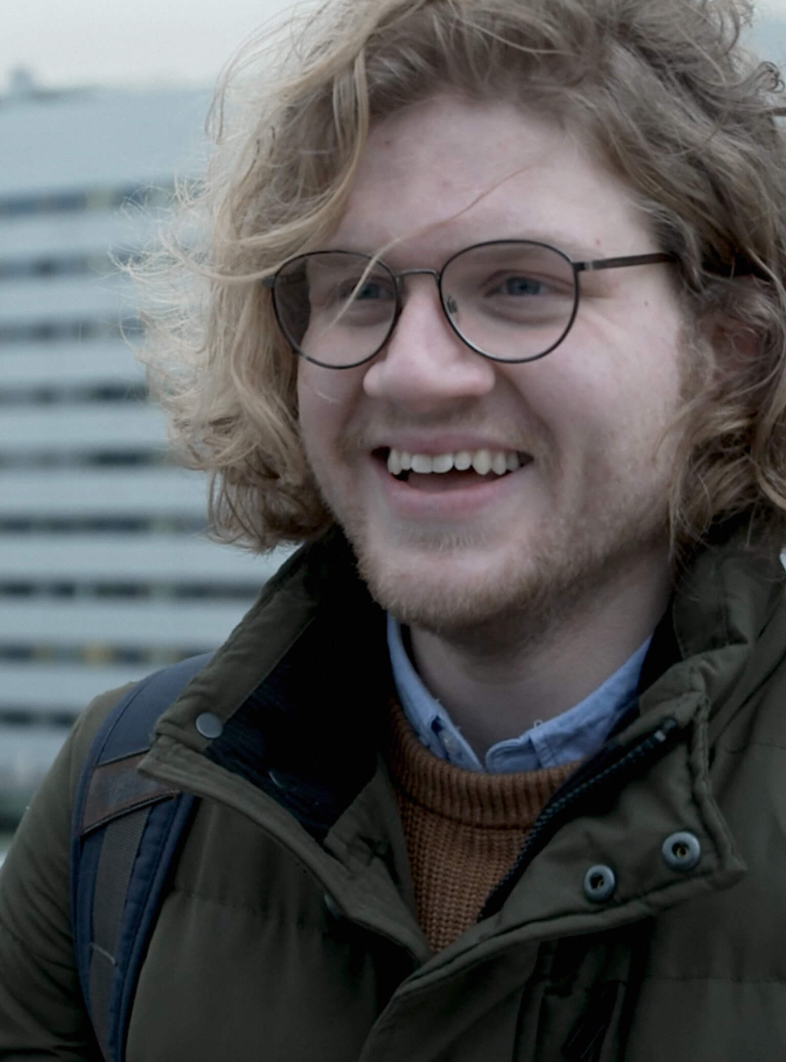 a portrait of Taher smiling